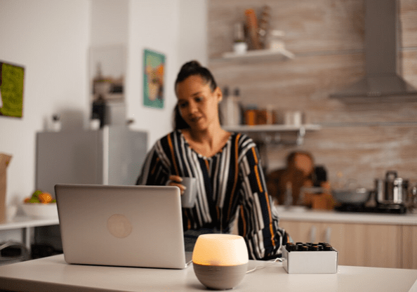 A woman sitting at her laptop on the counter